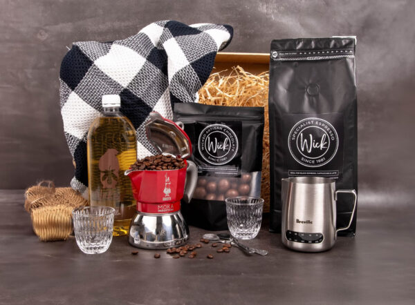 Stylized photo of Wick products including coffee beans, chocolates and coffee making utensils