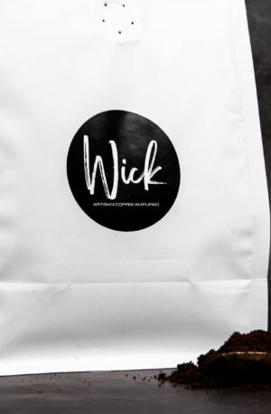 Stylized photo of Wick ground coffee and white coffee bag