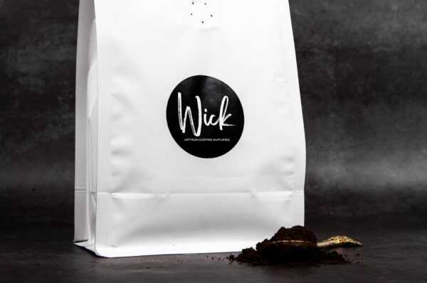 Stylized photo of Wick ground coffee and white coffee bag