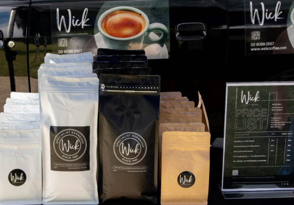 Stylized photo of Wick coffee products: coffee beans and chocolates for sale at the Wick van